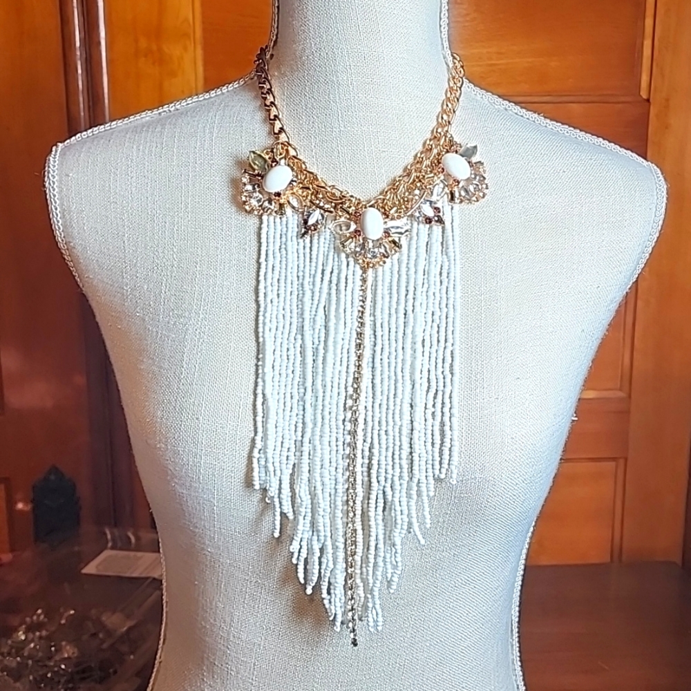 Large costume jeweled necklace, with many long beads and strand of gems.